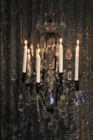 Very beautiful antique crystal chandelier in black iron frame with space for 
eight candles.