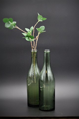 Dekorativ gammel glas flaske i grønt glas med en rigtig fin patina i selve 
glasset.
Rigtig fine som vase til en enkelt blomst eller som vandkarafler.