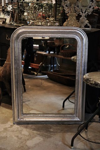 French 1800 century Louis Philippe silver fireplace mirror with fine decorated 
frame with pearl edge and original old mirror glass.
H:104cm. W:77cm.