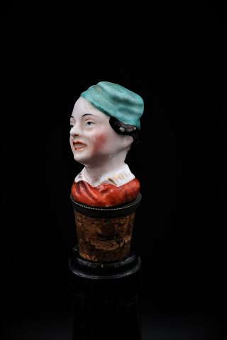 Funny, old wine stopper in painted porcelain with bust of Woman.
