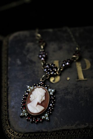 Old necklace with fine cameo and beautiful red garnets set in silver with chain. 
...