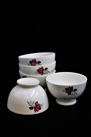 Old faience café latte bowl with a rose flower motif on the side...