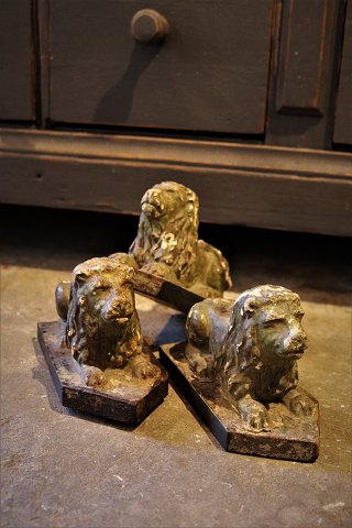 Decorative French 19th century lion in painted papier mache, with a fine old 
patina, lying on a wooden base...