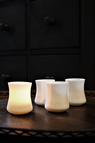Old candlesticks in white opal glass for tealights...