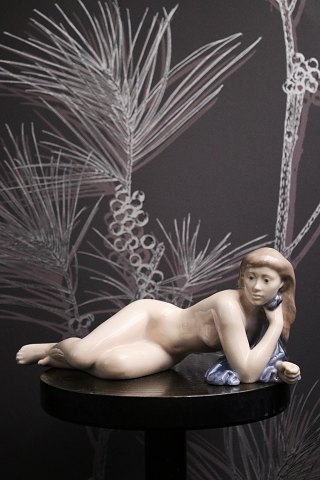 Royal Copenhagen porcelain figurine of a lying naked girl. 
RC# 4703.
Design John Galster...