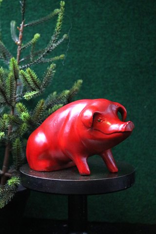 Decorative, old piggy bank in red painted terracotta from the 40s with a fine 
patina...