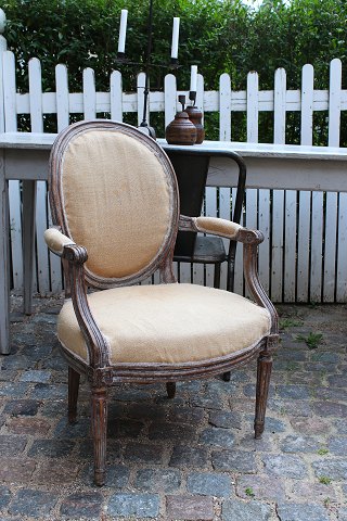 A pair of French 18th century Louis XVI armchairs with remnants of the original 
grey-blue colour...