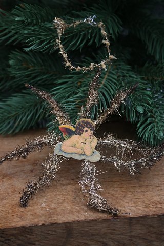 Antique tinsel Christmas tree ornament, cardboard angel with silver tinsel. 
Dia.: 15cm.