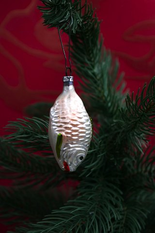 Old Christmas tree ornament in the shape of a small glass fish from 1940.