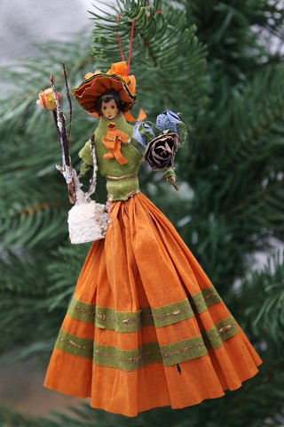 Old Christmas tree ornament, nice lady made of colored crepe paper with flower 
bouquet and small bird..