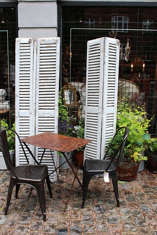 A pair of decorative old French shutters with original light grey patinated colour with slats...