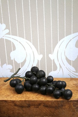 Old bunch of grapes with dark grapes made of cast glass material.