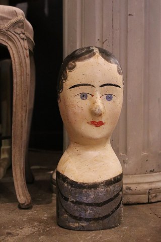 Decorative, antique French wig head (Millinery head) from the 19th century in painted papier-mâché...