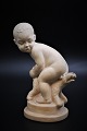 Little Svend Lindhart terracotta figure of child with dog. 
The figure is signed. 
H:17.5cm.