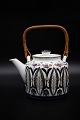 Faience teapot with wooden wicker handle from Aluminia, Baca series - Teneva. 
#437/3151.  H:12cm. Dia.:12cm.
