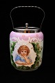 Old biscuit jar in painted opal glass 
decorated with a girl