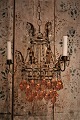 Old French chandelier in gilded metal, decorated with glass chains and glass 
balls in clear and pink colours...