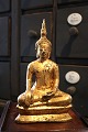 Old oriental buda in gilded iron. 
H: 22.5cm.