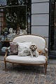 Empire salon sofa, gilded with a fine old patina and upholstered in light 
linen...