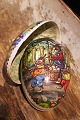 Old vintage Easter egg in papier-mâché with a motif of Easter bunnies collecting Easter eggs...