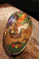 Old vintage Easter egg in papier-mâché with a motif of an Easter bunny and chickens collecting Easter eggs...