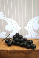 Old bunch of grapes with dark grapes made of cast glass material.