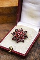 Old star shaped brooch with beautiful red garnets...