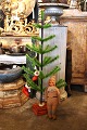 Christmas tree made of colored goose feathers mounted on an antique stand with red velvet fabric...